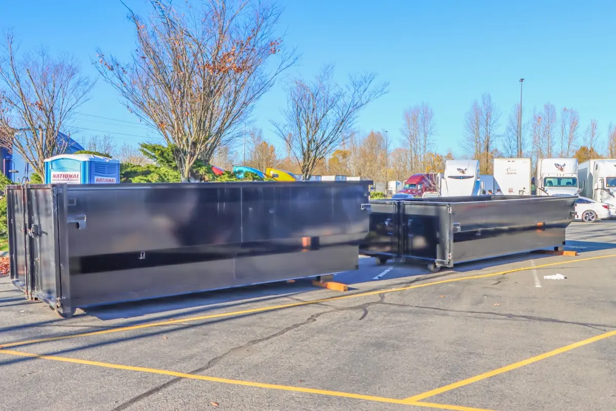 Professional dumpster rental service with roll-off container on residential driveway in Pottsville